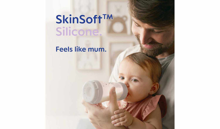 A parent feeding a baby with a silicone bottle, emphasizing the SkinSoft™ technology that mimics natural feeding.