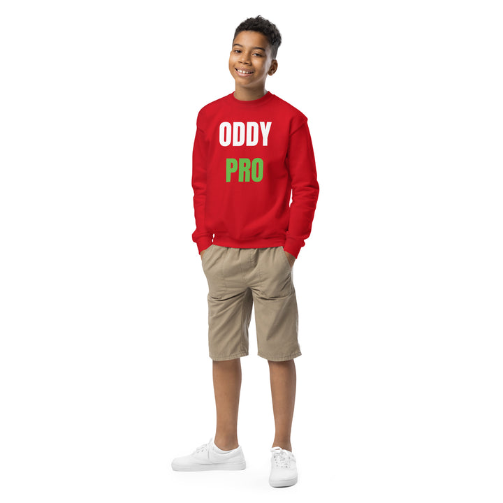 A smiling boy wearing an Oddy Pro Youth crewneck sweatshirt in red with khaki shorts, ideal for casual wear.
